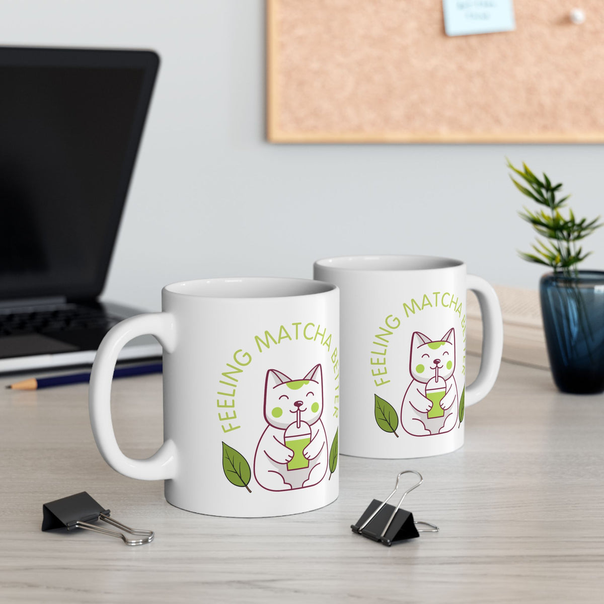 White ceramic matcha mug with a cute cat drinking matcha and the text “Feeling Matcha Better,” view of both sides