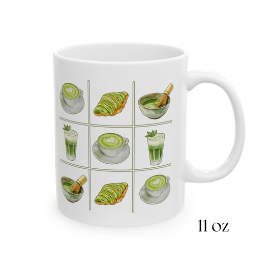 Close-up view of 11oz white ceramic mug with a matcha tic-tac-toe design of green lattes, matcha croissants, iced matcha, and whisked matcha bowls