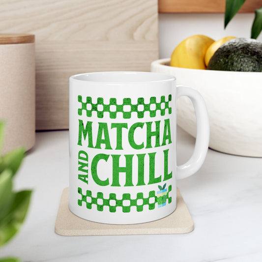 White ceramic matcha mug with a checkered border above and below the text “Matcha and Chill,” resting on a trivet on a kitchen counter
