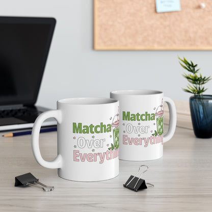 View of both sides of a white ceramic matcha mug with an iced matcha latte illustration surrounded by tiny hearts and stars and the text “Matcha Over Everything” 