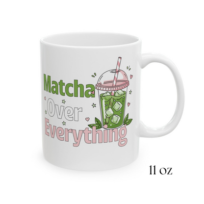 Close-up of a 11oz white ceramic matcha mug with an iced matcha latte illustration surrounded by tiny hearts and stars and the text “Matcha Over Everything” 