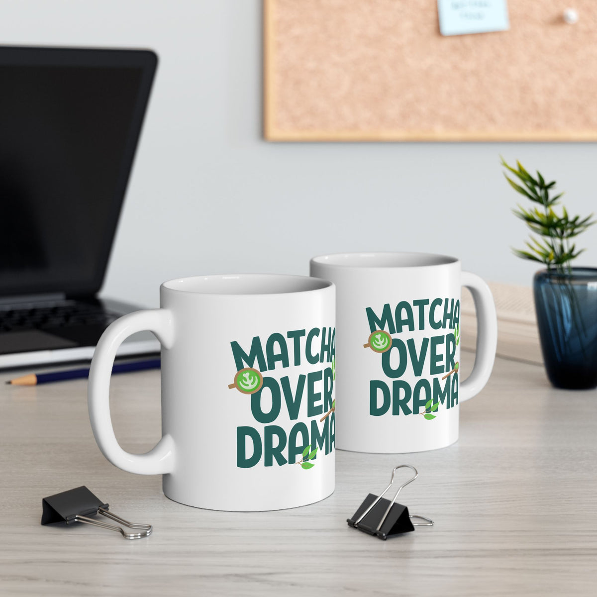White ceramic "Matcha Over Drama" coffee mug with mini images of green tea leaves, a matcha latte, and wooden spoon filled with matcha powder, view of both sides